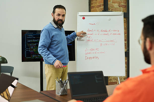 Instructor leading a classroom-style rehabilitation or life skills training session for individuals preparing for recovery and community reintegration.