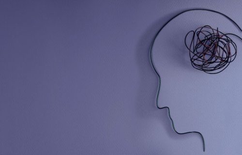 Abstract wire sculpture of a human head profile with tangled wires representing the mental burden of anxiety, depression, and co-occurring disorders